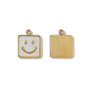 Macro shot of square titanium steel pendants with white shell inlay and golden smiley face