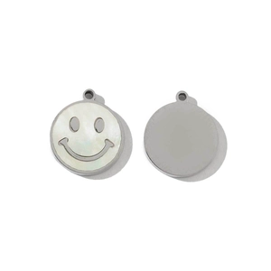 Macro shot of silver-tone stainless steel smiley face charm with iridescent white shell inlay