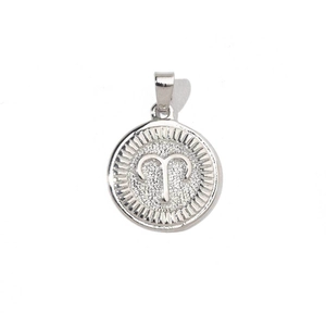 Macro detail of Aries zodiac charm in silver with sunburst texture and relief symbol