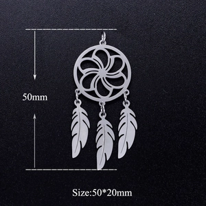 Detail of silver stainless steel lotus dreamcatcher pendant with feather tassels