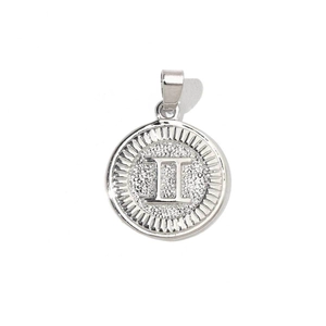 Macro detail of silver zodiac pendant with Roman numeral II and textured metal finish