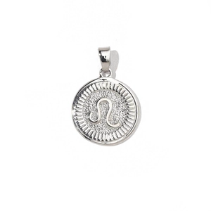 Macro shot of silver zodiac charm with Leo constellation and radial pattern details