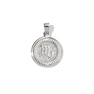 Macro view of silver Scorpio zodiac charm pendant with sparkling textured background
