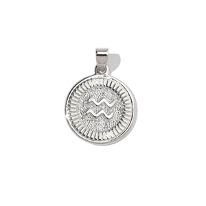 Macro shot of silver Aquarius zodiac charm with cubic zirconia and sunburst texture