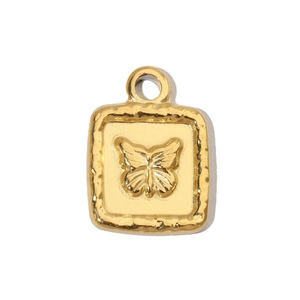 Detailed close-up of a vintage gold butterfly relief on a rectangular steel pendant