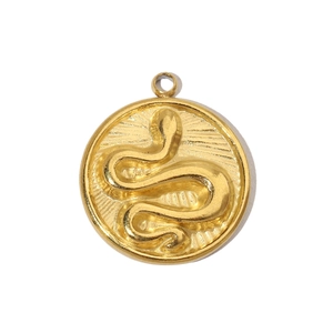 Detailed close-up of a vintage gold snake pendant with embossed texture and relief design