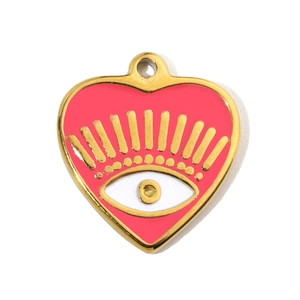 Macro view of heart-shaped gold pendant with pink enamel and evil eye pattern