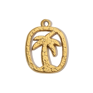Macro detail of a golden palm tree pendant with a textured hammered finish on an oval frame