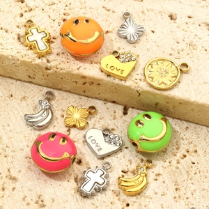 Assorted DIY jewelry pendants with smiley faces, love hearts, and banana charms
