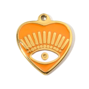 Detailed view of heart-shaped evil eye pendant with orange enamel and gold metal eyelashes