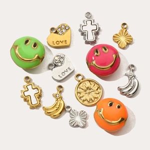 Assorted gold and silver plated charms including smileys, hearts, and crosses for necklaces
