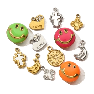 Mix of stainless steel charms including colorful smiles, heart pendants and a cross