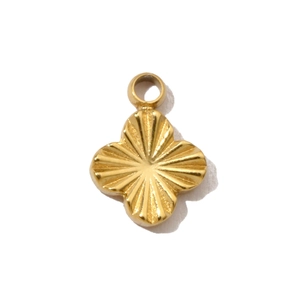 Macro view of gold quatrefoil pendant with detailed sunburst radial guilloché texture
