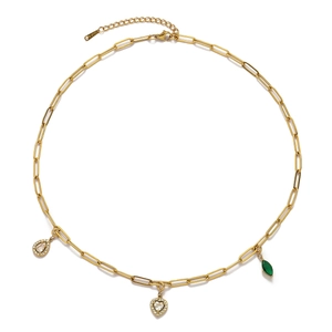 Detail of gold paperclip chain necklace with heart and emerald zircon pendants