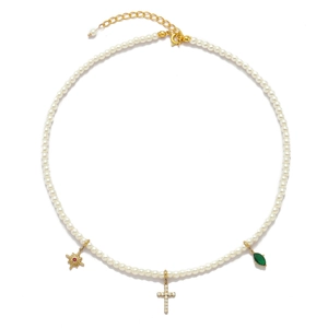 Detail of pearl necklace featuring star, cross and emerald green zircon pendants
