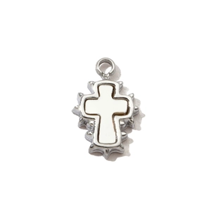 Detailed macro view of silver Gothic cross pendant with white inlay and spiked edges