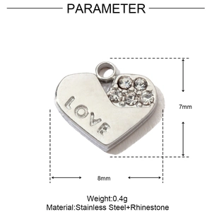 Macro detail of a heart-shaped stainless steel pendant with LOVE engraving and zircons