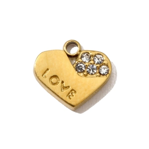 Macro shot of gold heart pendant with LOVE engraving and clear zircon stone accents