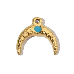 Close-up of golden crescent moon pendant with hammered texture and turquoise heart detail