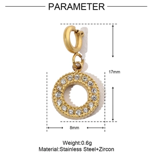 Macro detail of a 17mm gold stainless steel charm with zircon and 8mm circular diameter