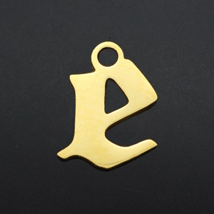 Macro shot of gothic lowercase letter e pendant in gold-plated stainless steel