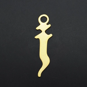 Macro view of a gold-plated stainless steel alphabet pendant on black textured background