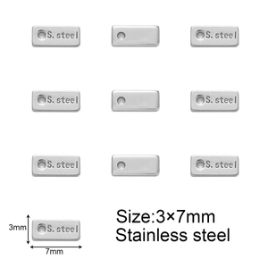 Close-up of 3x7mm silver stainless steel rectangle tags with S. Steel engraved detail