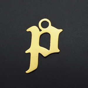 Macro detail of gold plated Gothic letter P pendant with top bail for DIY jewelry