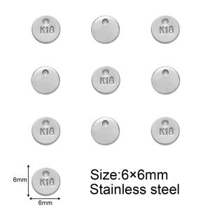 Detail view of 6mm circular stainless steel tags with K18 engraving for jewelry making