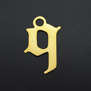 Detailed macro view of a gold-plated Gothic letter G pendant with a matte finish
