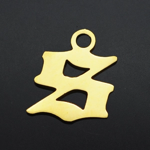 Macro shot of gold Gothic letter S pendant with brushed metal finish for DIY jewelry