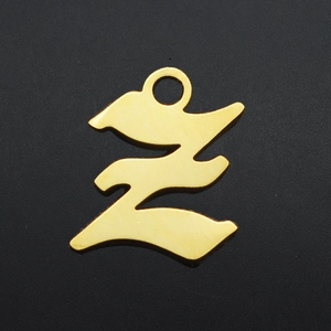 Macro detail of Gothic letter Z pendant in polished gold-plated stainless steel