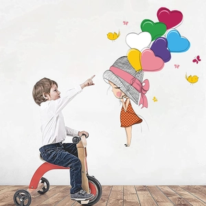 Detail of DIY cartoon girl with heart balloons wall sticker in a cozy nursery playroom