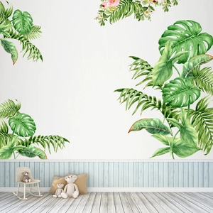 Detail of tropical green leaf wall decals with monstera and palm leaves for room decor