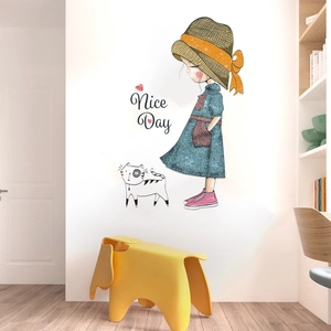 Detail of cartoon girl and cat wall sticker featuring Nice Day text and yellow straw hat