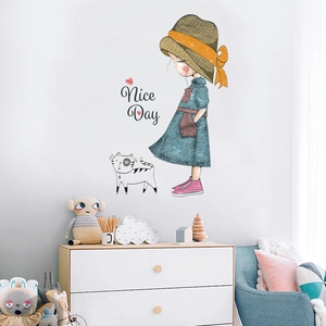 Detail view of cartoon girl and cat wall stickers in a modern kids bedroom setting