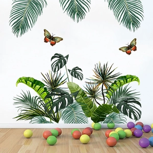 Macro view of tropical palm leaf and monstera wall decals with colorful butterflies