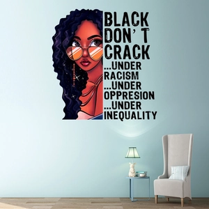 Black girl wall decal with orange sunglasses and stylish hair in a blue living room