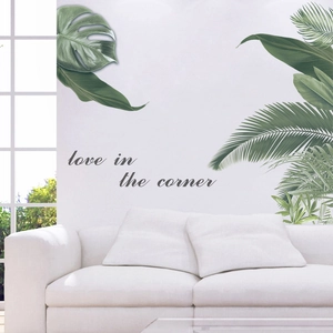 Modern Monstera tropical leaf wall stickers with 'love in the corner' text on a white wall