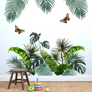 Detail of tropical green leaf wall stickers with realistic butterflies in a cozy room
