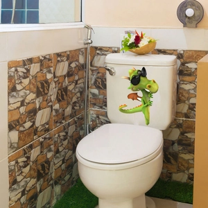 Funny 3D green dinosaur with sunglasses toilet sticker applied on a bathroom tank