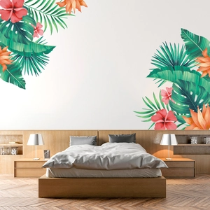 Tropical wall decals with green monstera leaves and red hibiscus in a modern bedroom décor