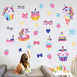 Girl interacting with colorful unicorn ice cream wall decals in a cozy kids bedroom