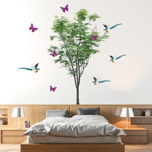 Modern wall sticker featuring lush green tree with blue birds and pink butterflies
