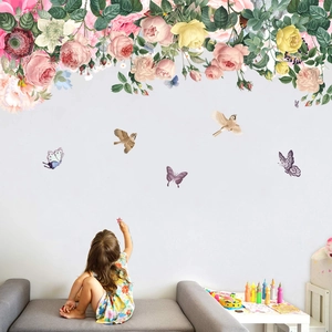 Detail of vintage floral wall stickers with roses and birds in a cozy bedroom setting