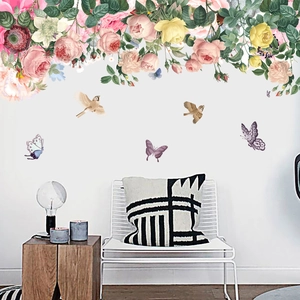 Detail of pink rose wall stickers with birds and butterflies in a modern living room decor