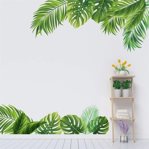 Detail of tropical monstera leaf wall stickers in a bright green bedroom setting