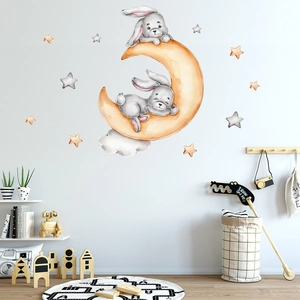 Detail view of two cute bunnies on a yellow moon wall sticker for kids' rooms