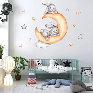 Detailed view of watercolor bunny moon and stars wall stickers in a nursery room setting