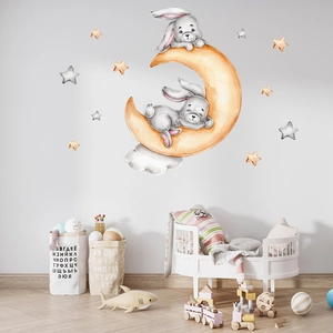 Watercolor wall sticker with two rabbits sleeping on an orange moon and yellow stars